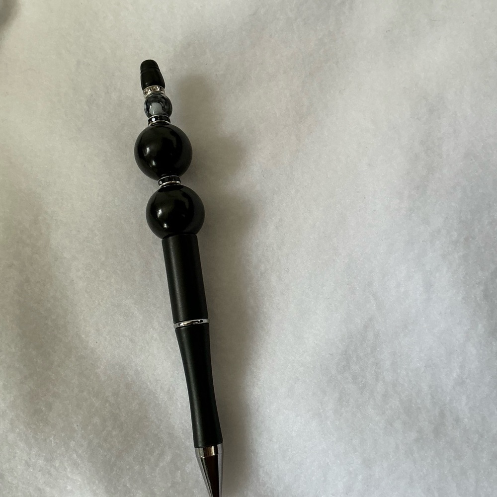 Beaded pen, black ink .